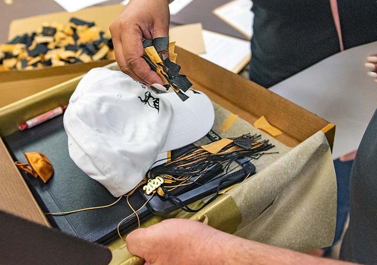 Items being placed in a commencement keepsake box