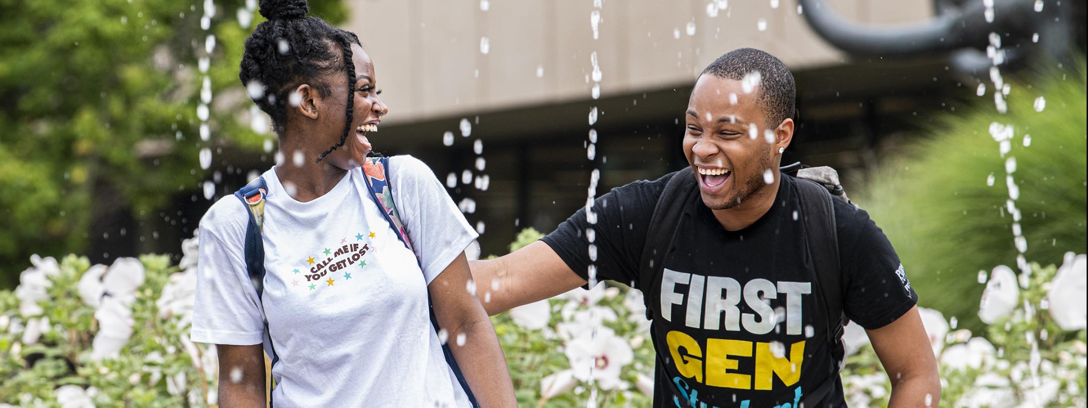 Two students near the fountain in Alumni Plaza