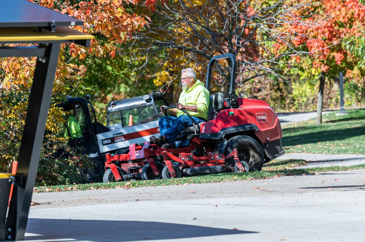 Facilities mowing campus lawn.