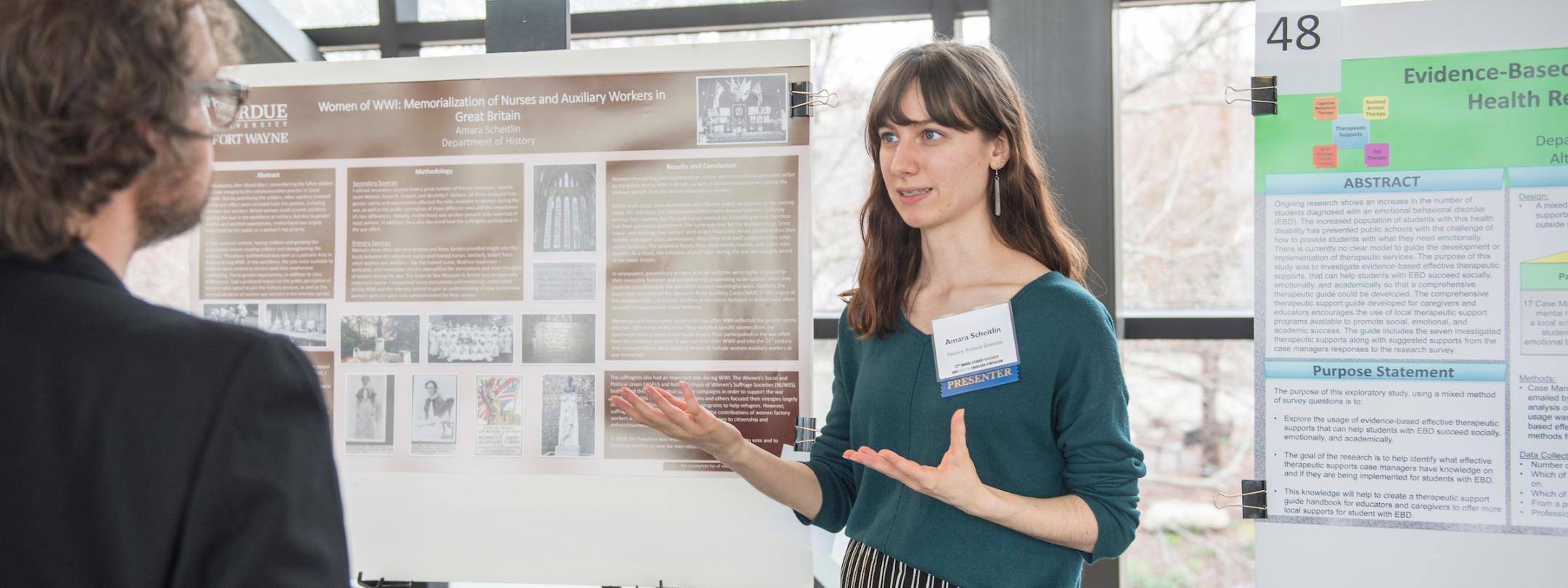 Student showing poster