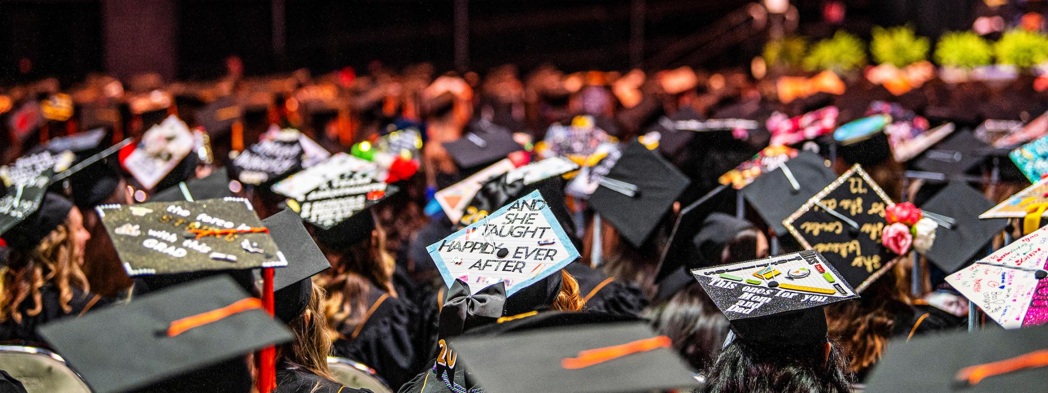 A sea of graduation caps in the crowd.