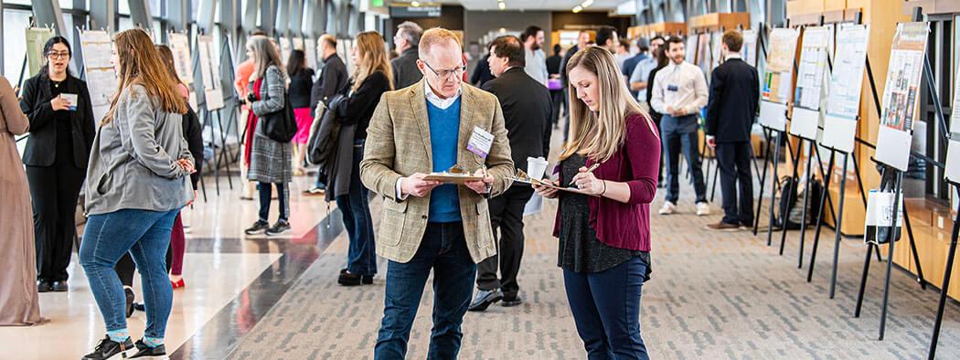 Judges compare notes at the Student Research and Creative Endeavor Symposium