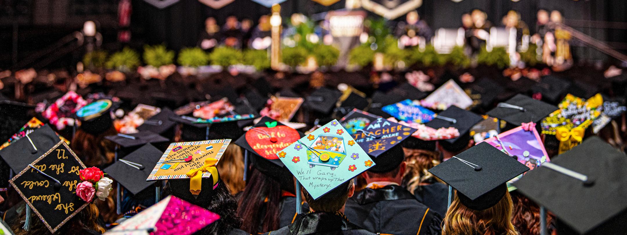 Students look toward the stage at commencement.