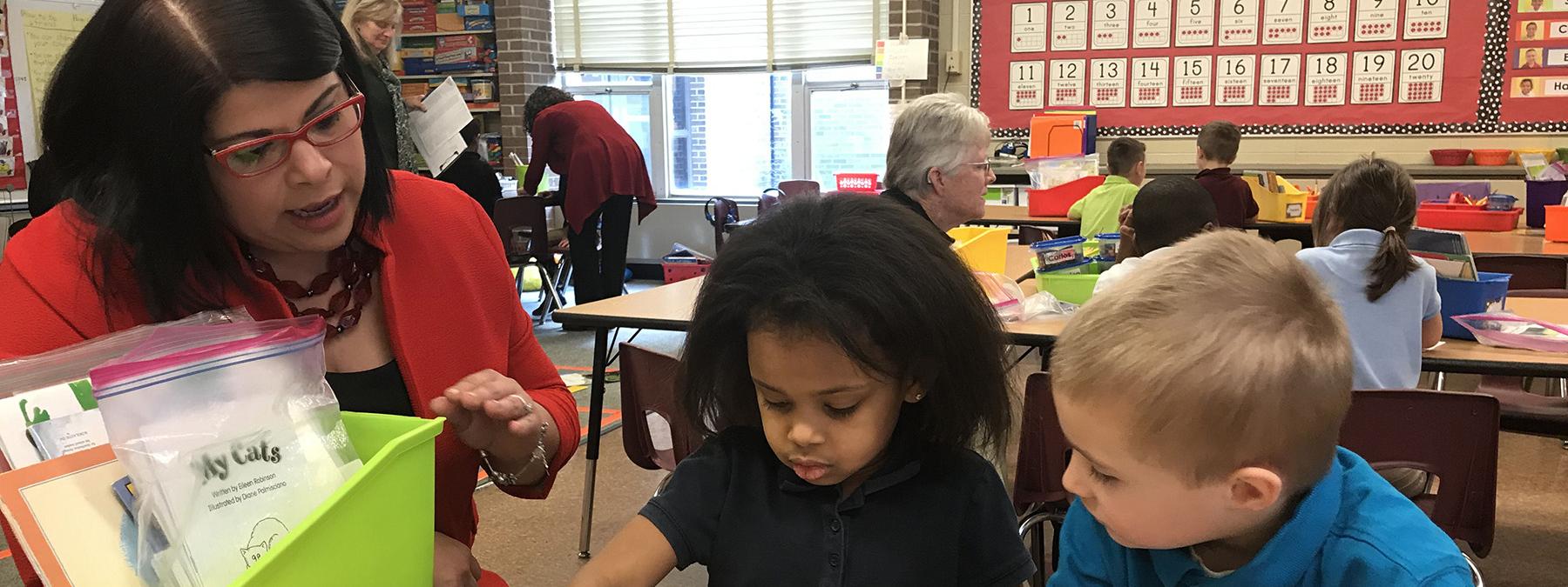 Maria Norman is working with elementary school students.