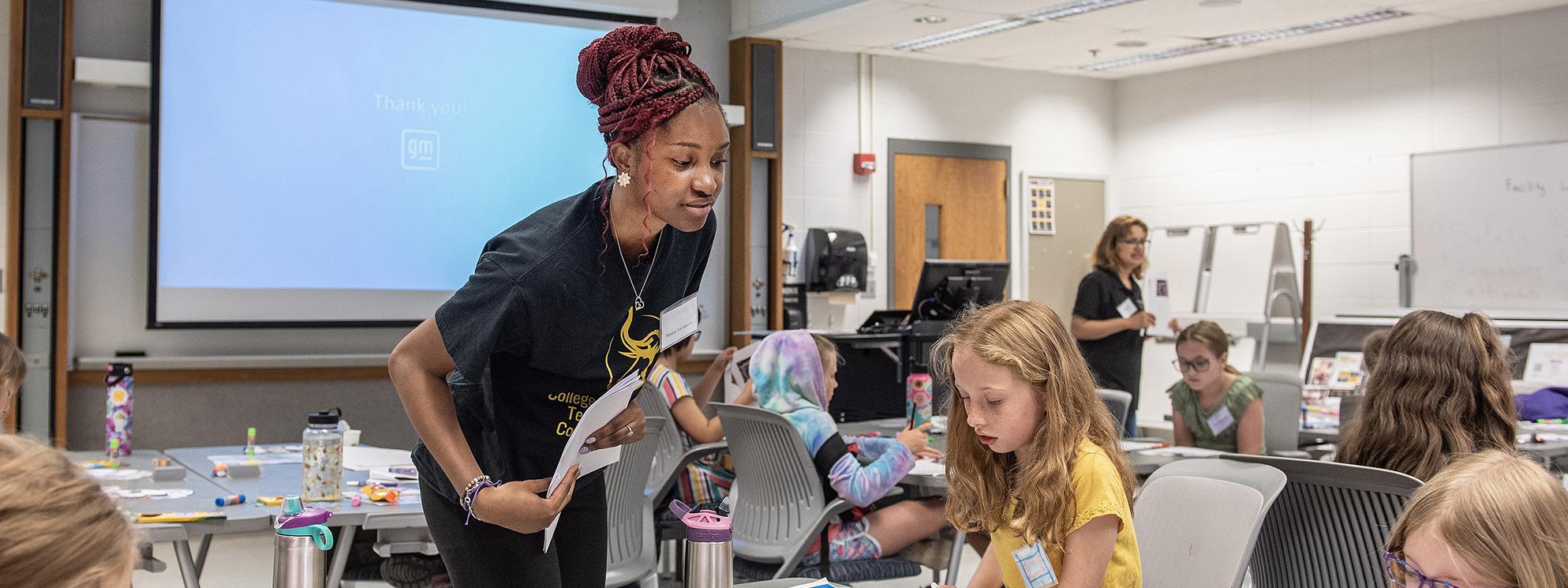 A PFW student works with you learners in an immersive summer camp program.