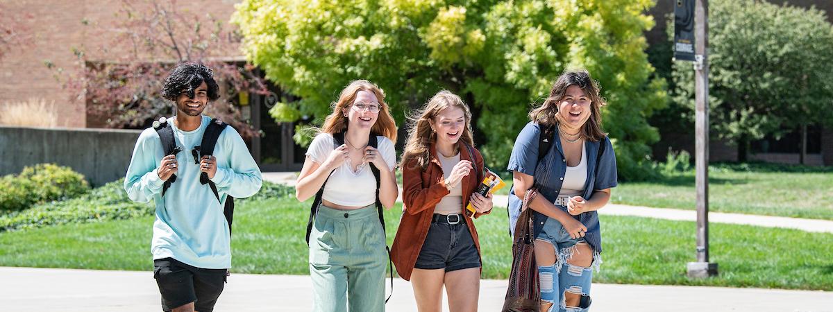 Students walk across campus together.