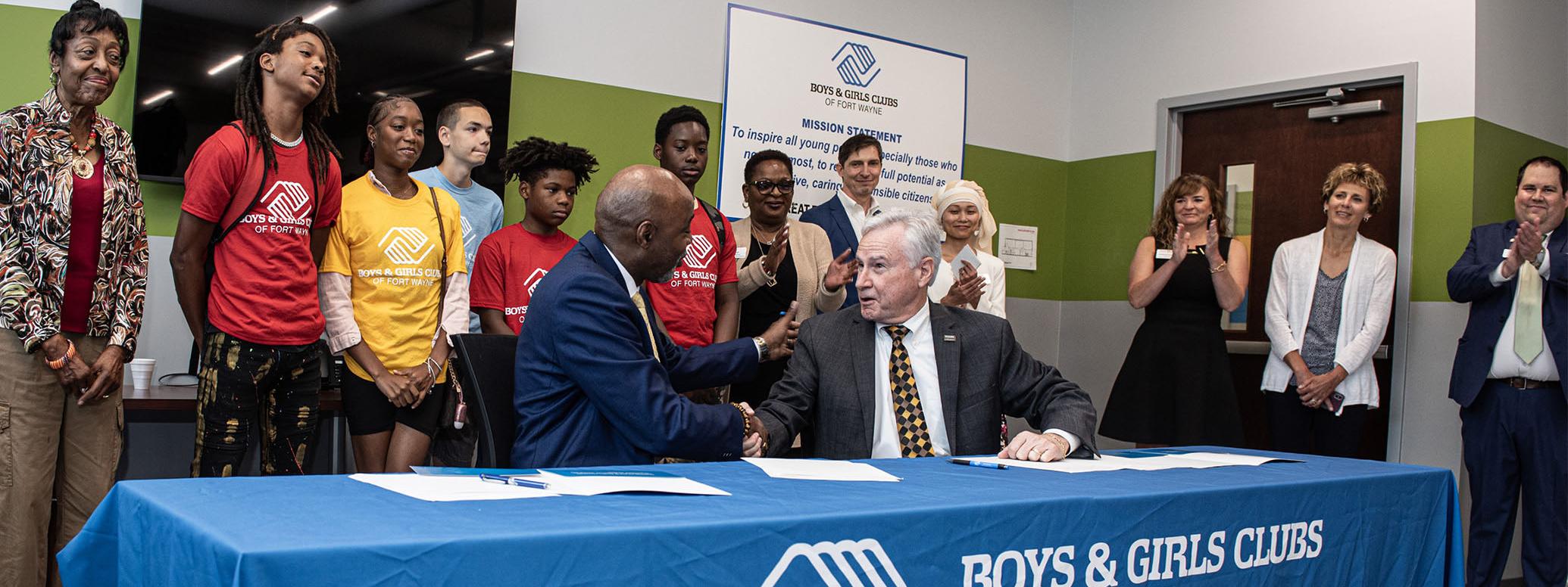 Joe Jordan, president and CEO of the Boys & Girls Clubs, and Chancellor Ron Elsenbaumer of PFW sign the paperwork to officially usher in this next chapter of collaboration between the two entities.