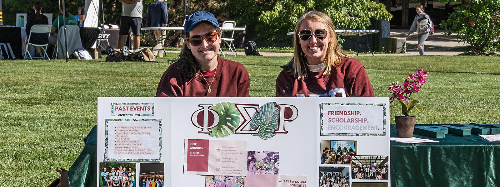 Two members of Phi Sigma Rho at the PFW connections fair
