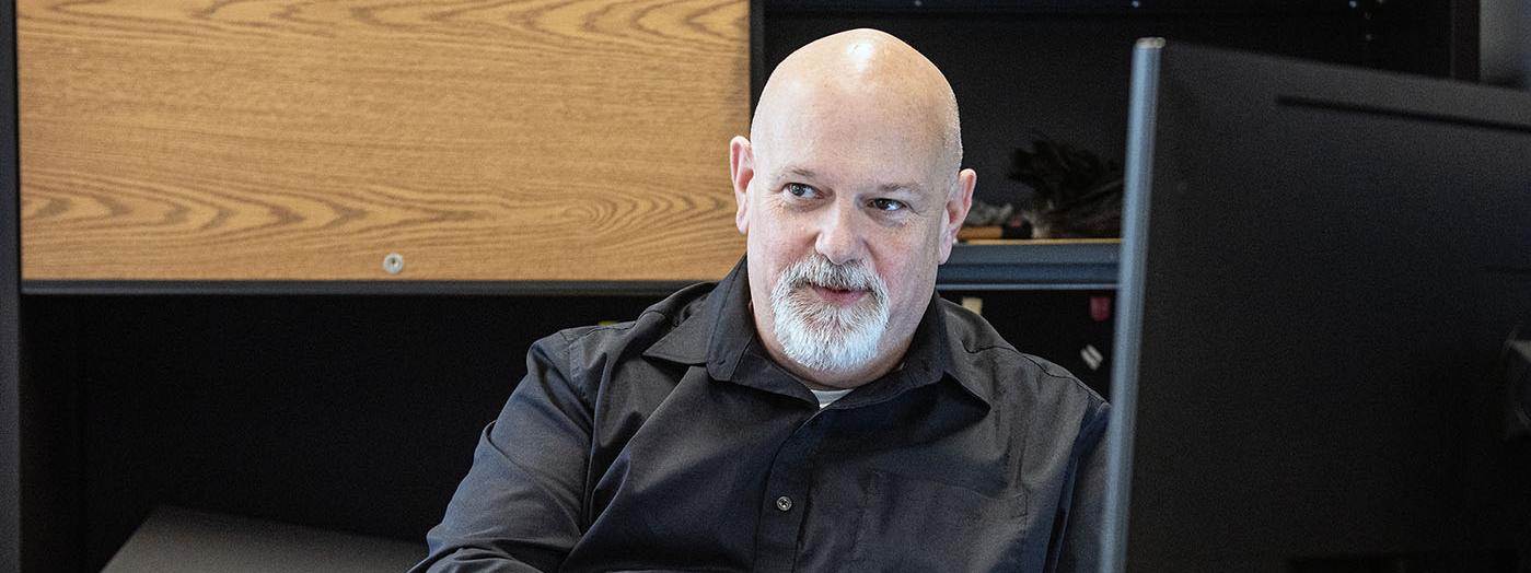Portrait of Ron Herrell sitting behind a desk
