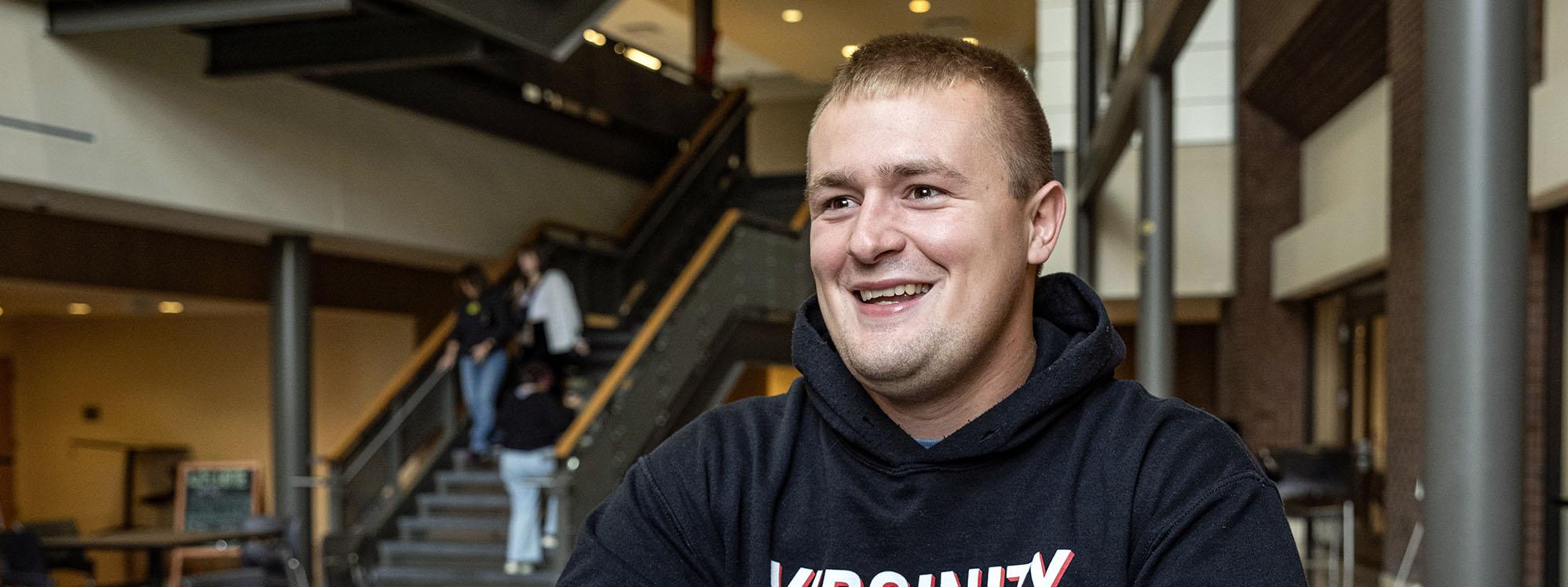 Evan Gregory is seated in the Walb Union Atrium