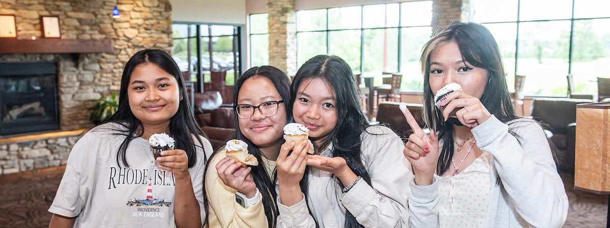 Women holding cupcakes