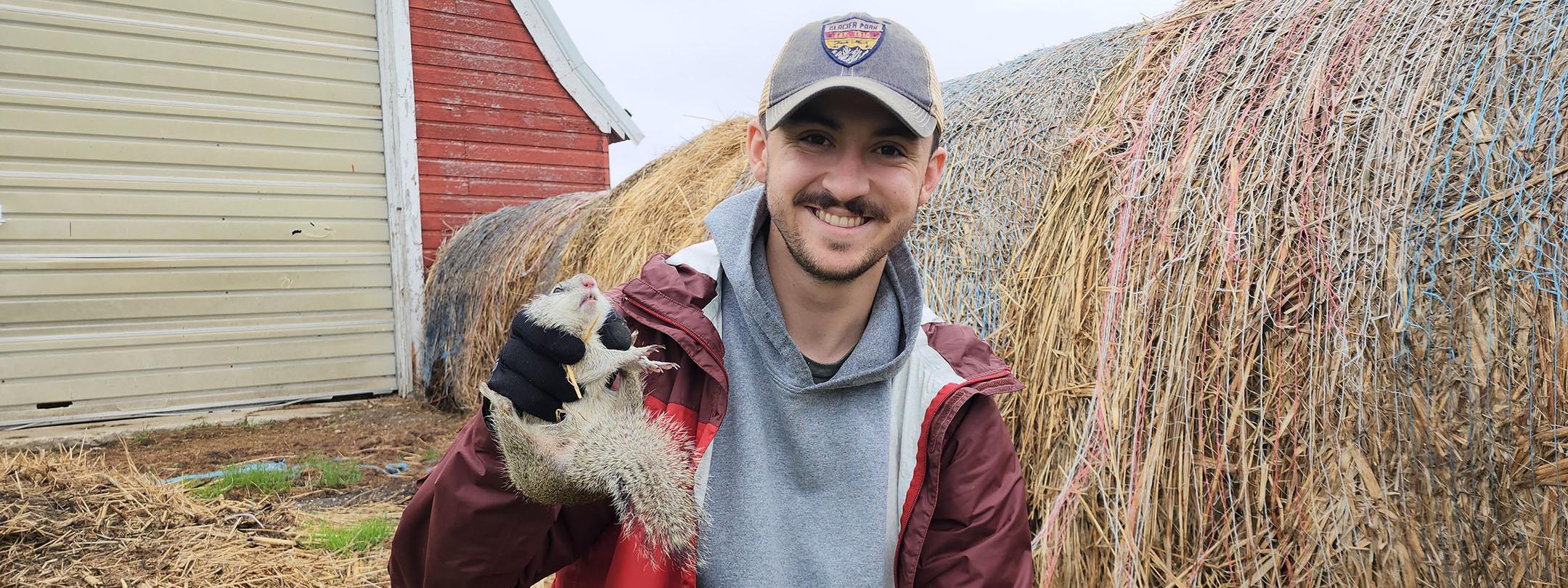 Justin Moore, graduate research assistant, with a Franklin's ground squirrel.