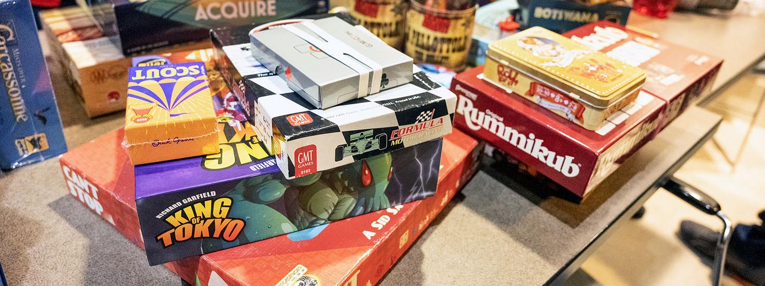 A table piled with board games.