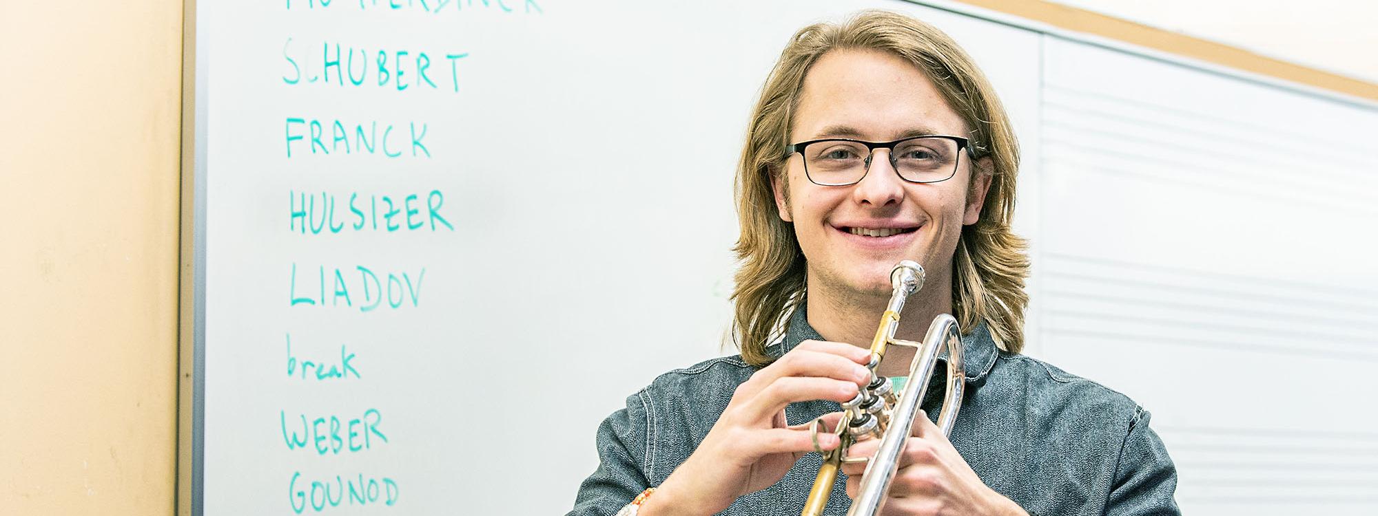 Austin Hulsizer is holding a trumpet