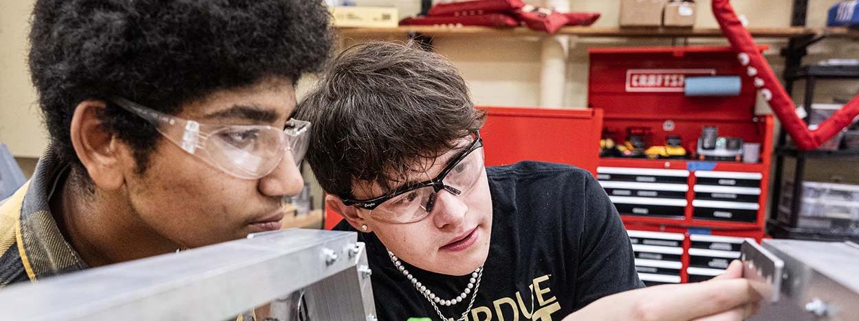 Drew Clem is working with robotics team students