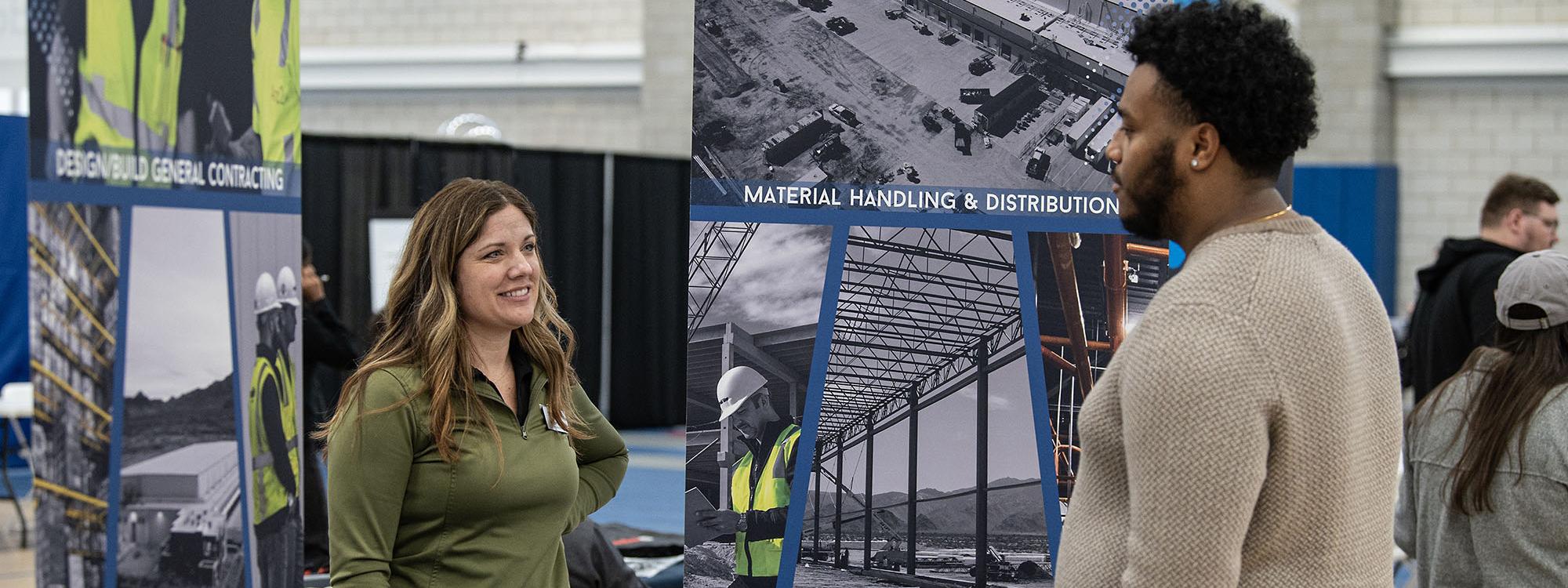 A student and employer at a career expo