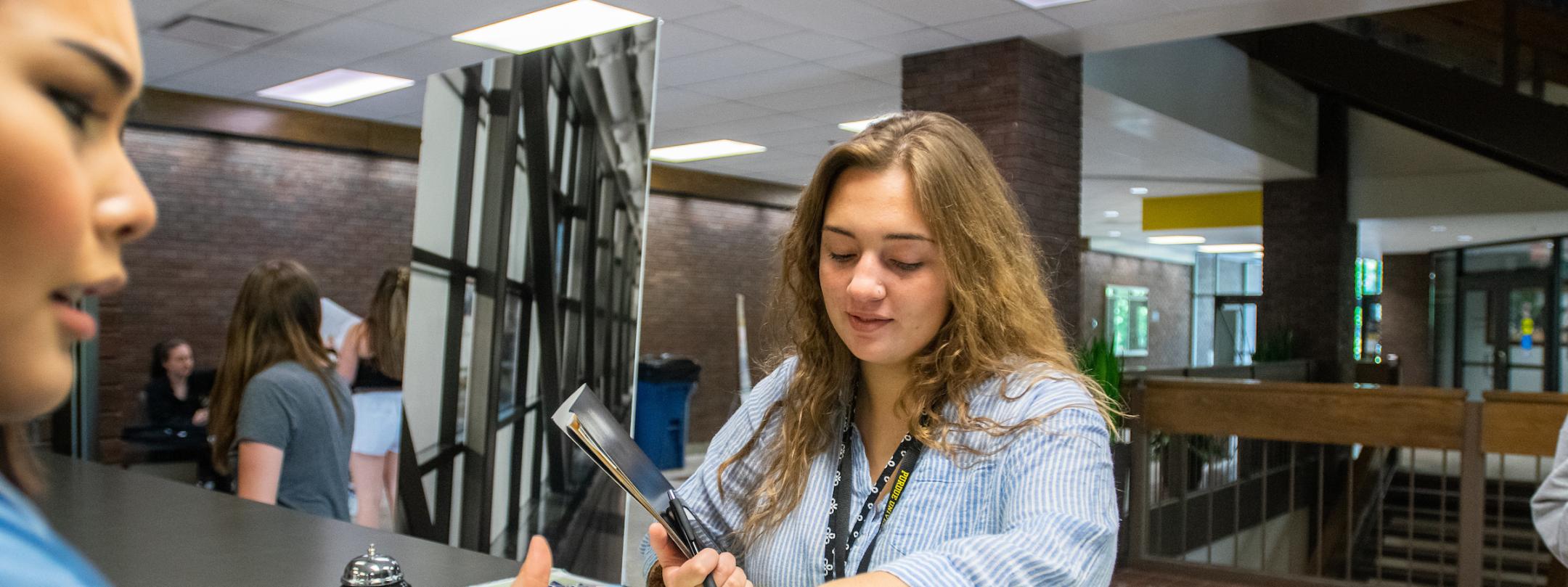 Student receiving Mastodon ID card.