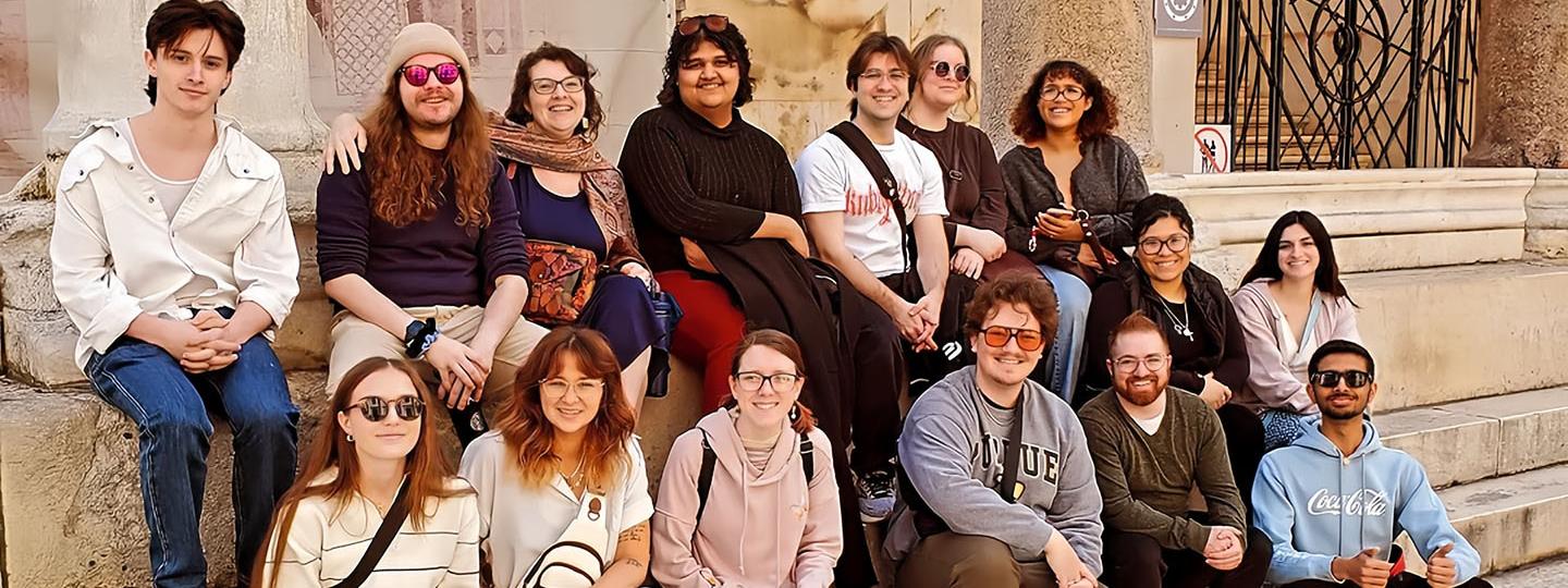 A group of PFW students sitting on stairsteps in Croatia
