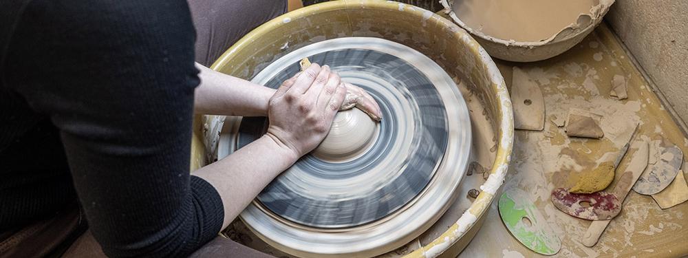 Turning a bowl on a pottery wheel.
