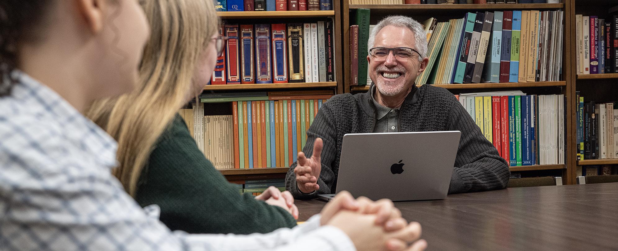 Students meet with their professor.
