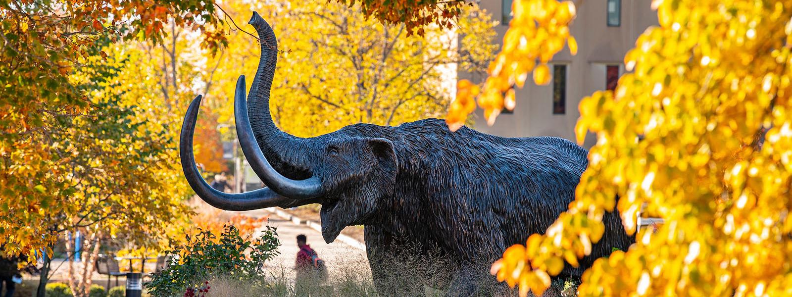 Mastodon statue surrounded by gold leaves