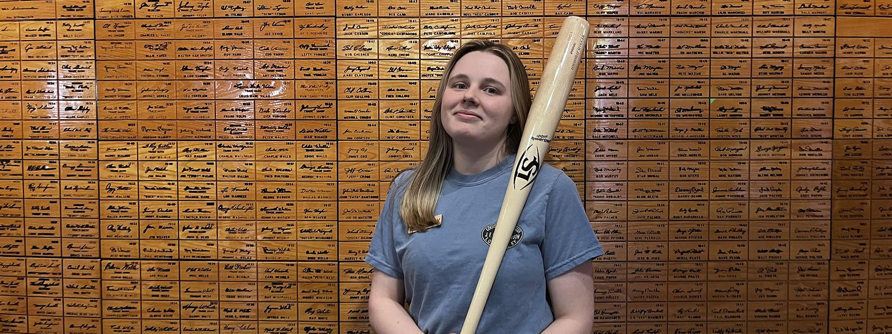 Hailey Bower holding a baseball bat