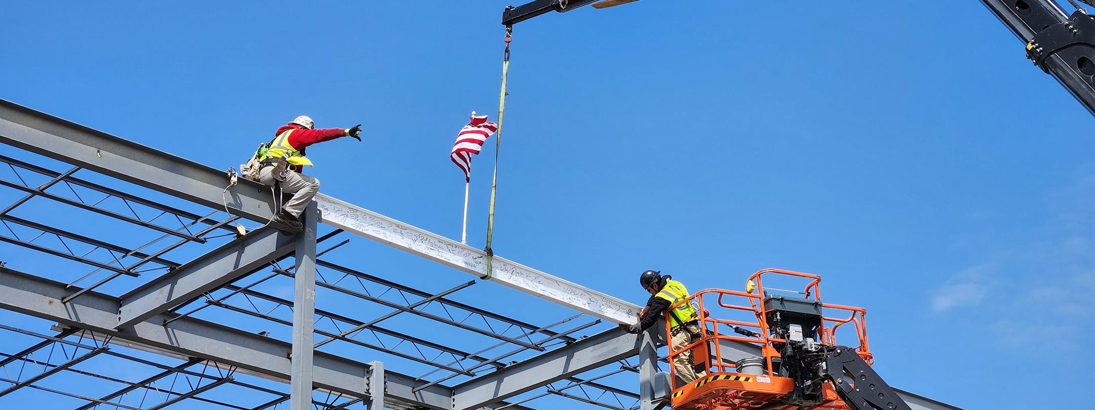 The final beam is placed atop the Music Industry building