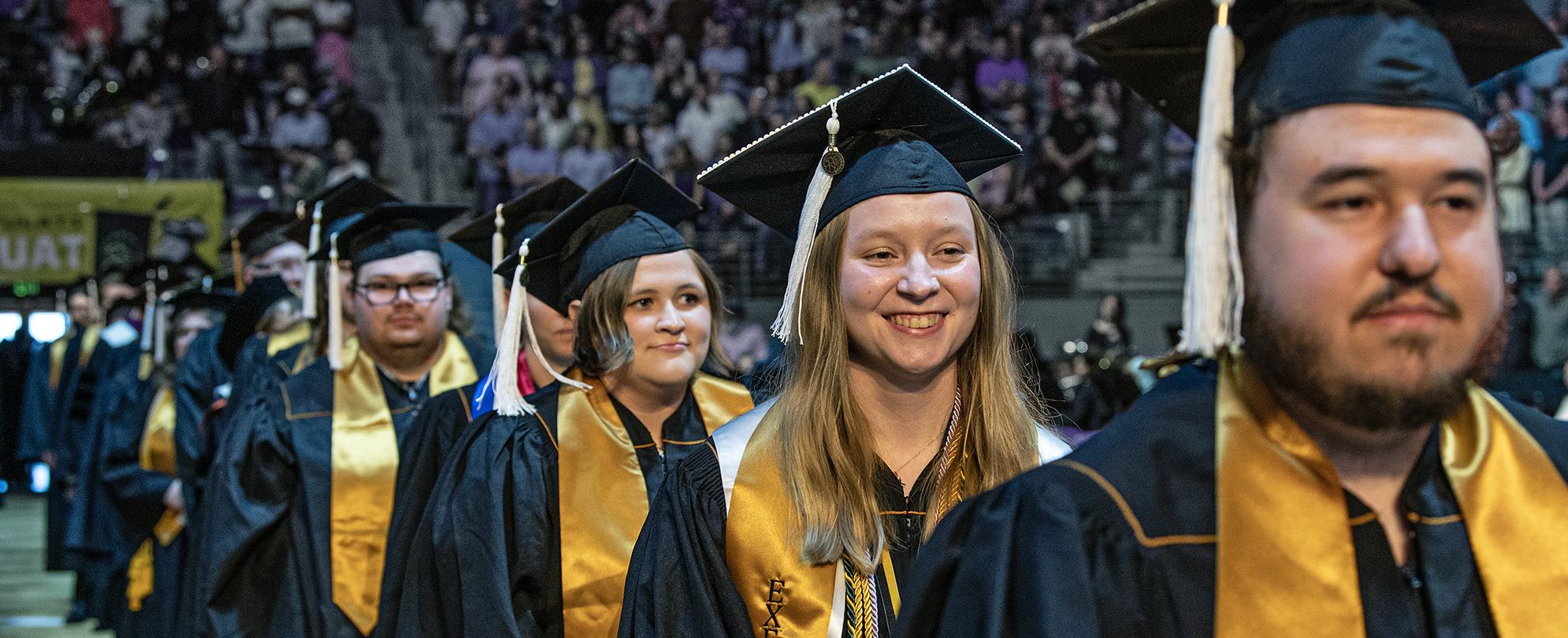 Students walking into the coliseum for commencement.