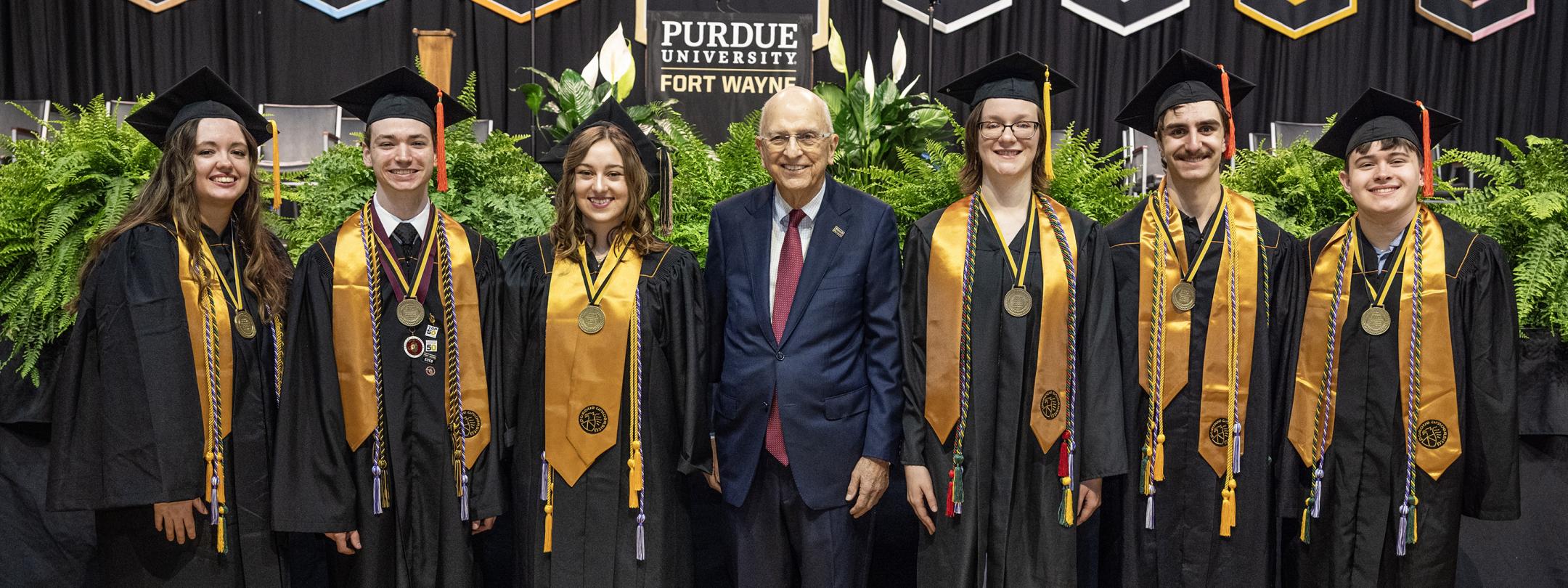 Group of 2025 Chapman Scholar graduates with Mr. Howard Chapman