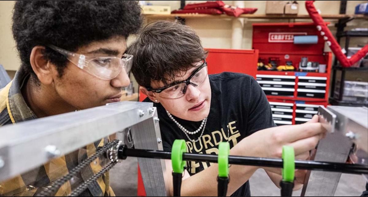 Close of of two individuals working on an engineering project.