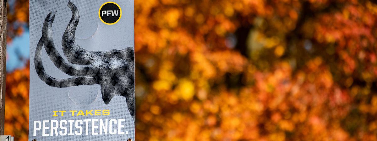 A mastodon banner backed up by fall foliage