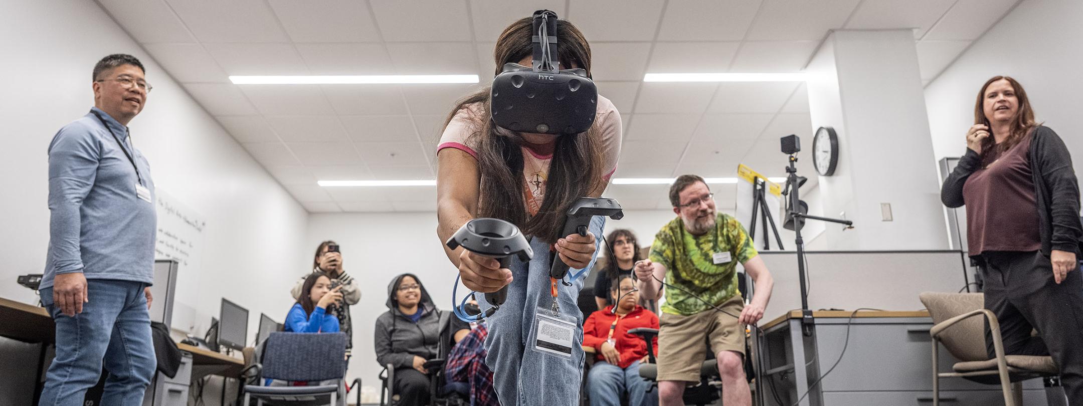A student is walking on a balance beam while wearing a VR headset