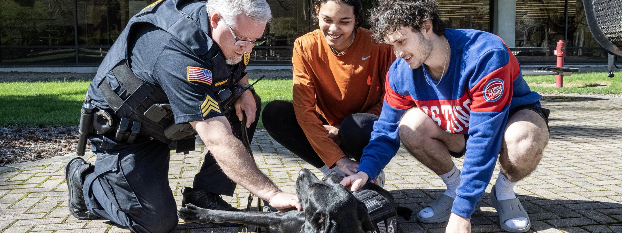 Students playing with Recon the police dog.