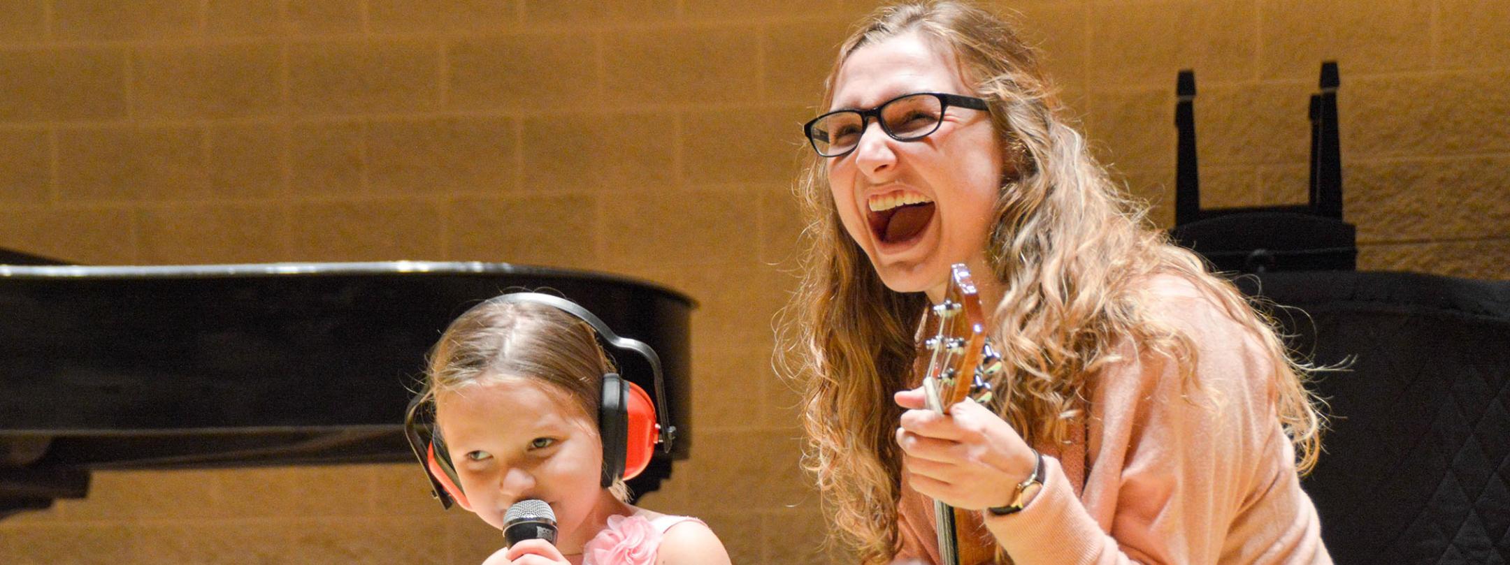 A music therapist is performing with a client