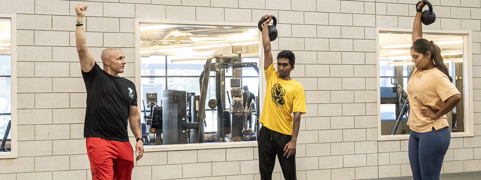 A police officer is leading a CrossFit class