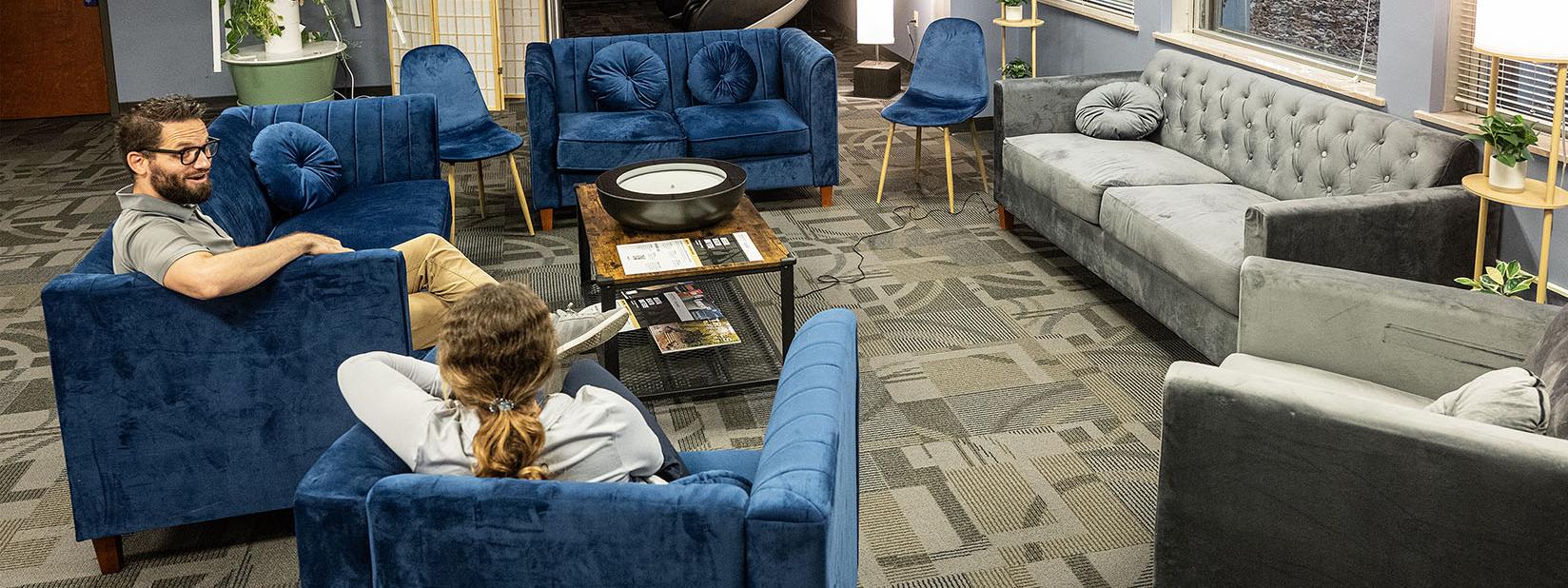 Two people relaxing on easy chairs