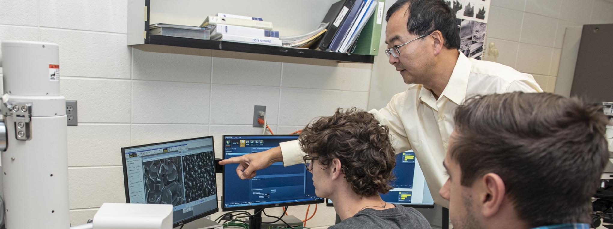 Professor and students using the scanning electron microscope