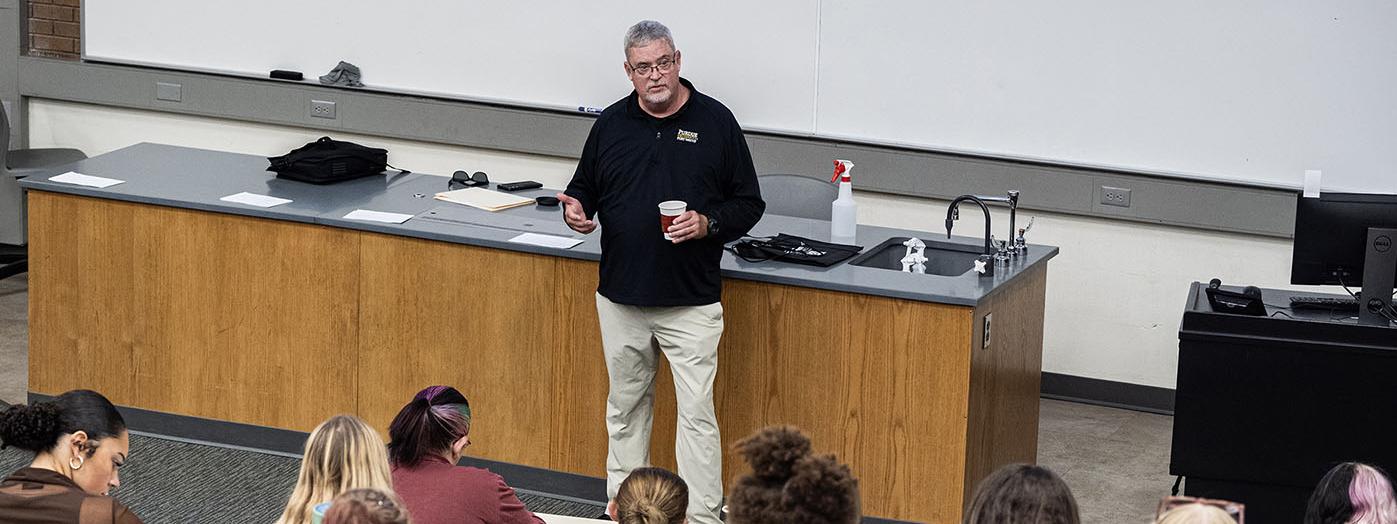 Carl Drummond is teaching a class in a lecture hall