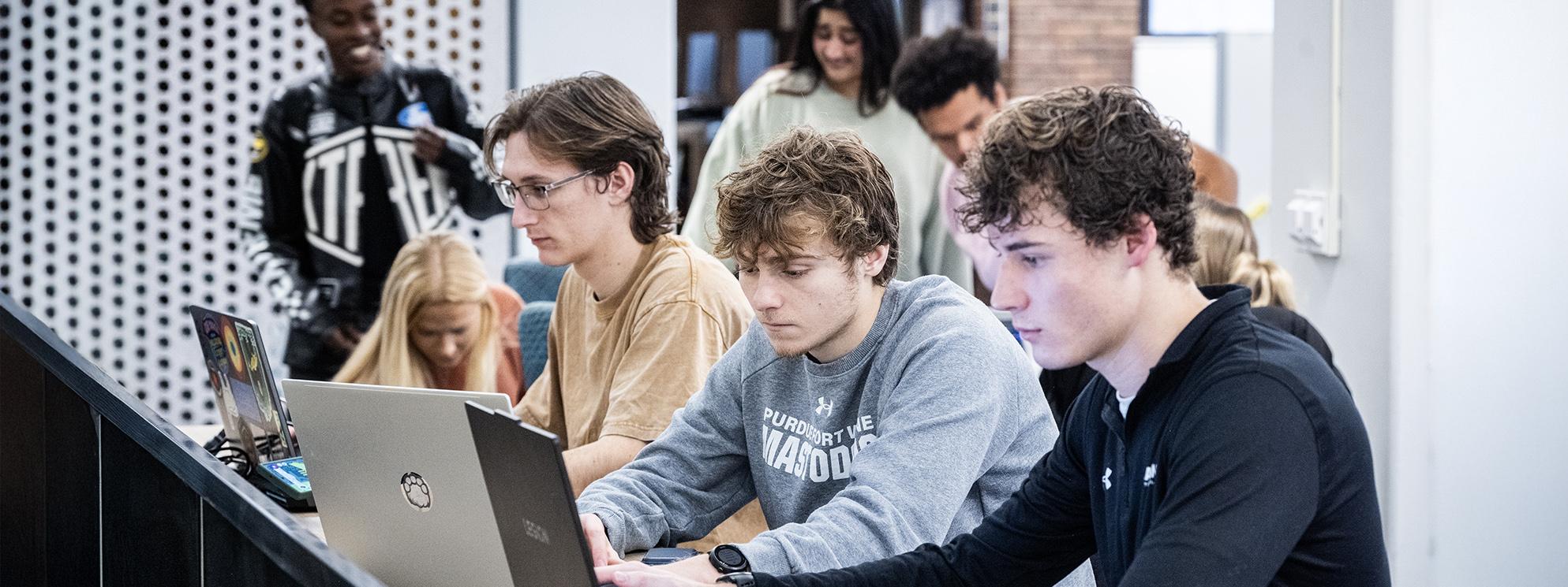 Students studying on laptops.