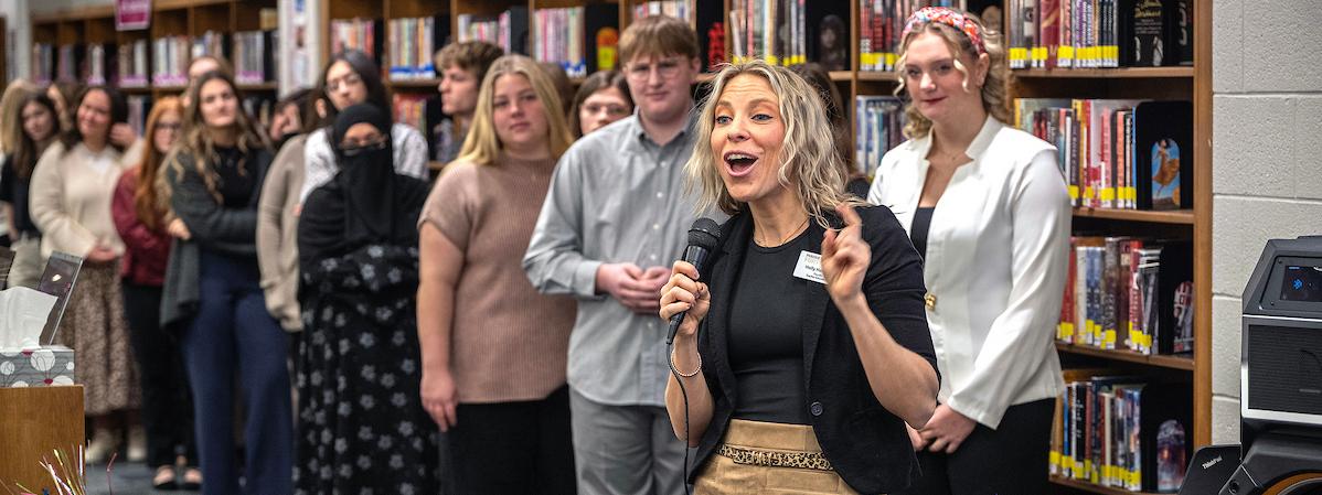 School of education students are lined up in front of a classroom