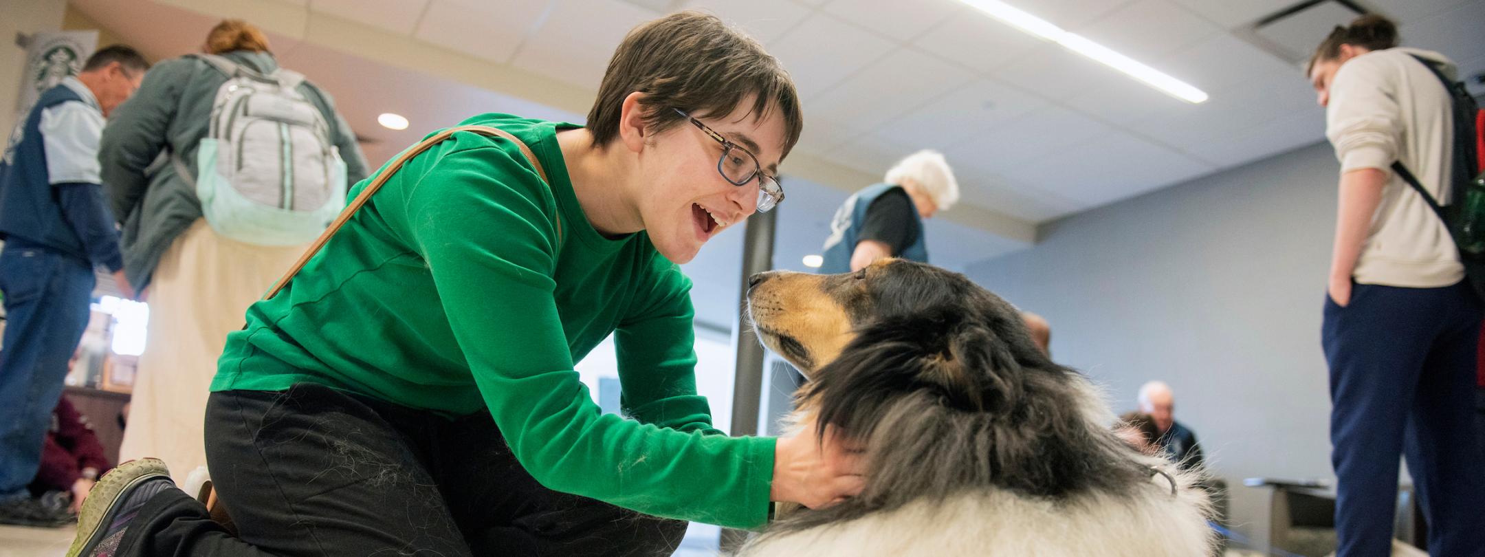 Student with a therapy dog.