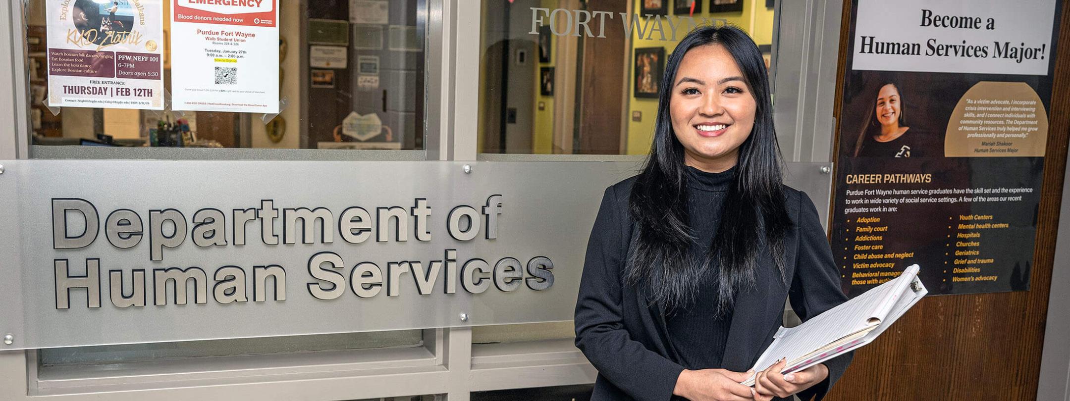 Mansan Kiim is standing outside of a department