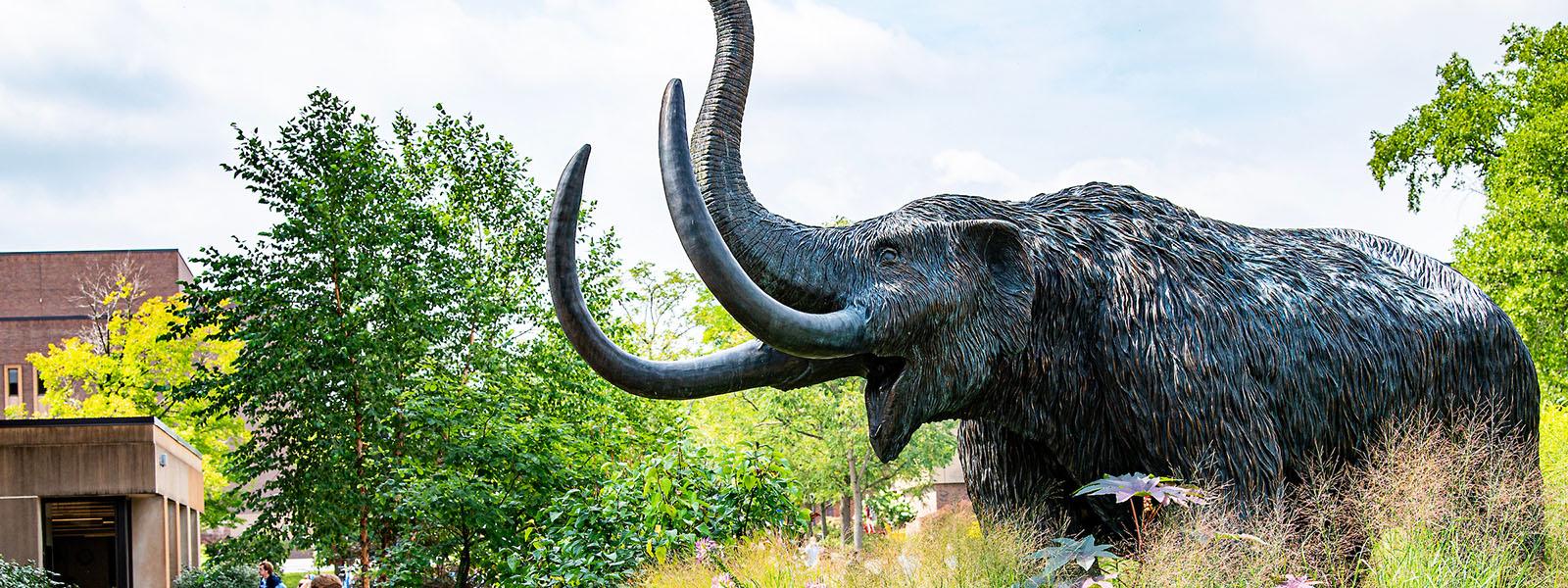 Bronze mastodon statue in the summertime