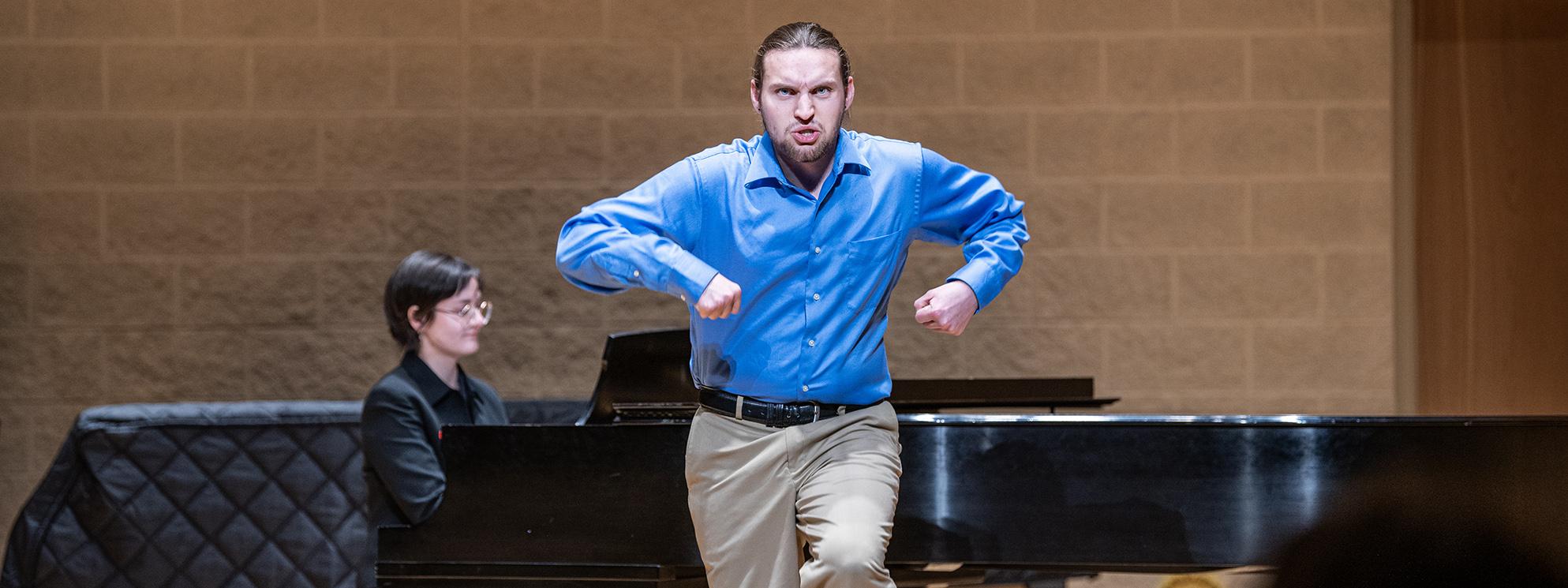 Student plays a piano during a visual arts performance