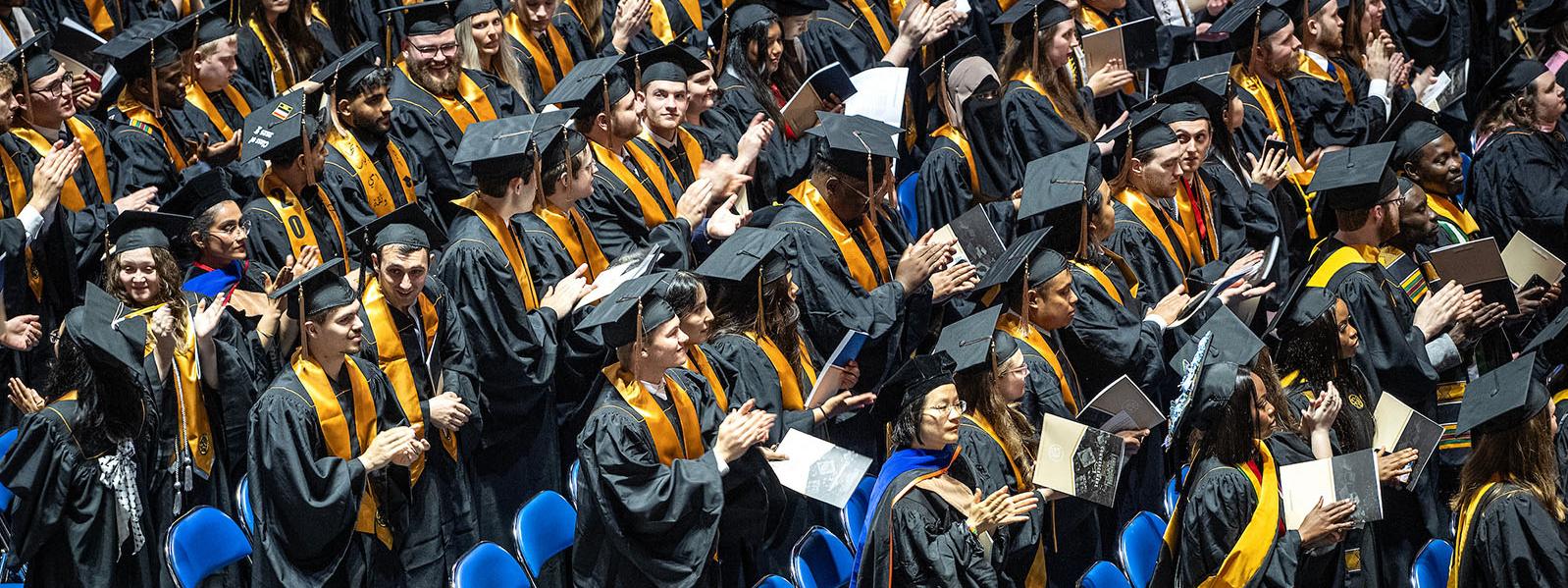Group shot of many graduates at commencement