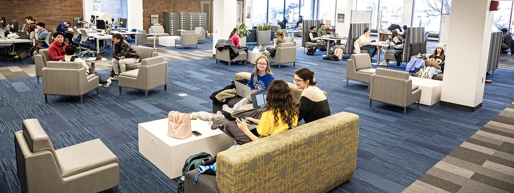 Students studying on the first floor of the Helmke libary