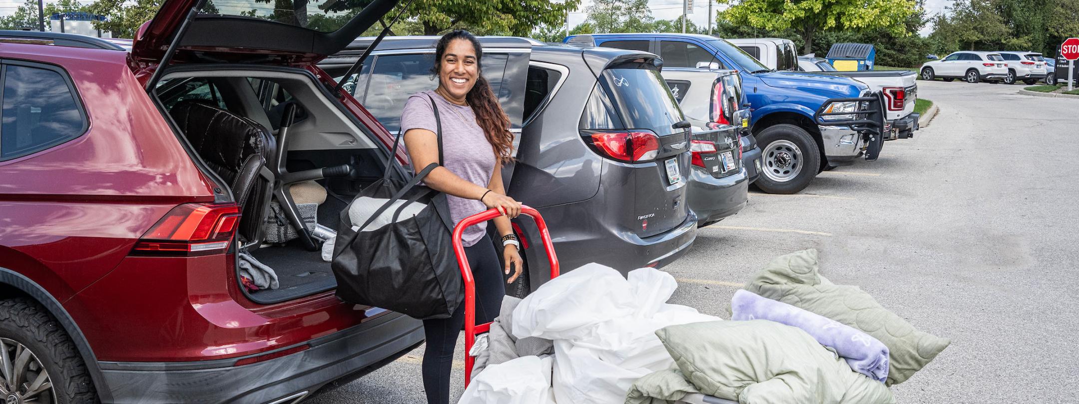 A student is moving personal items on a cart