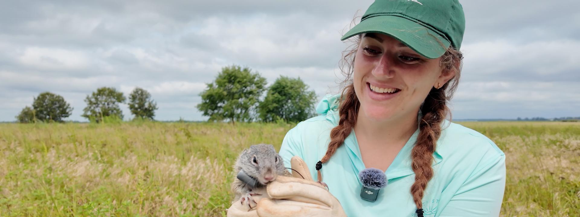 A student is holding a ground squirrel