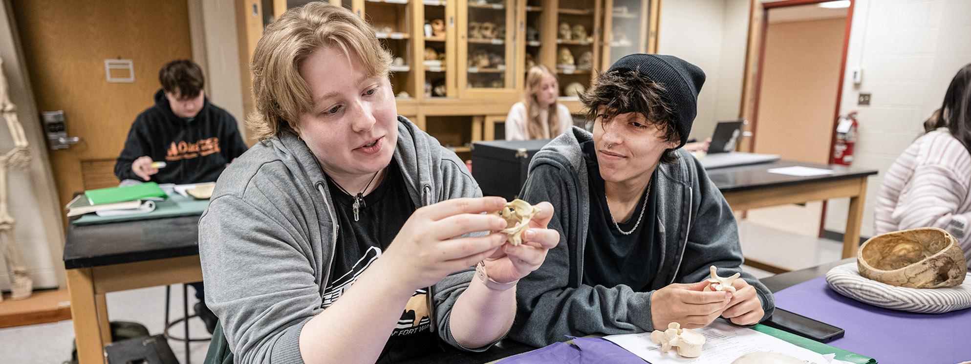 Two students engaging with an activity in the anthropology lab