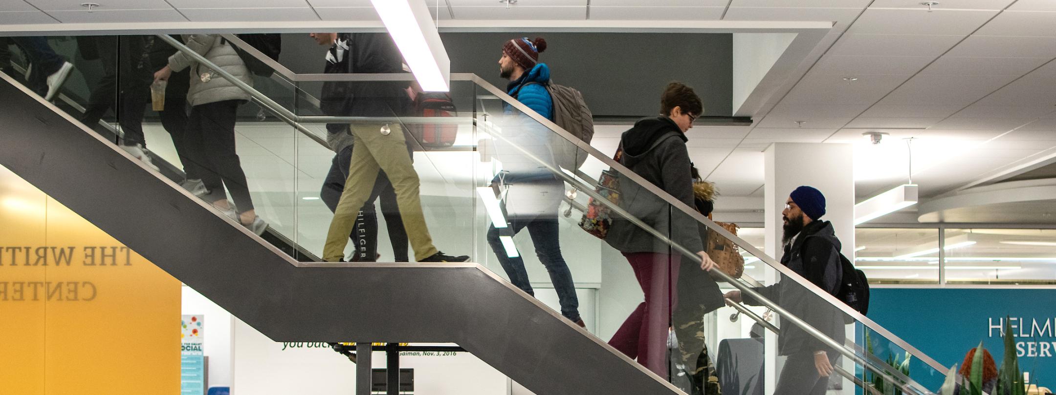 Students ascending and descending central library stairwell